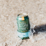 Can of Sunday Road Brewing Coast Track Lager beer on sand with water splash in Cronulla