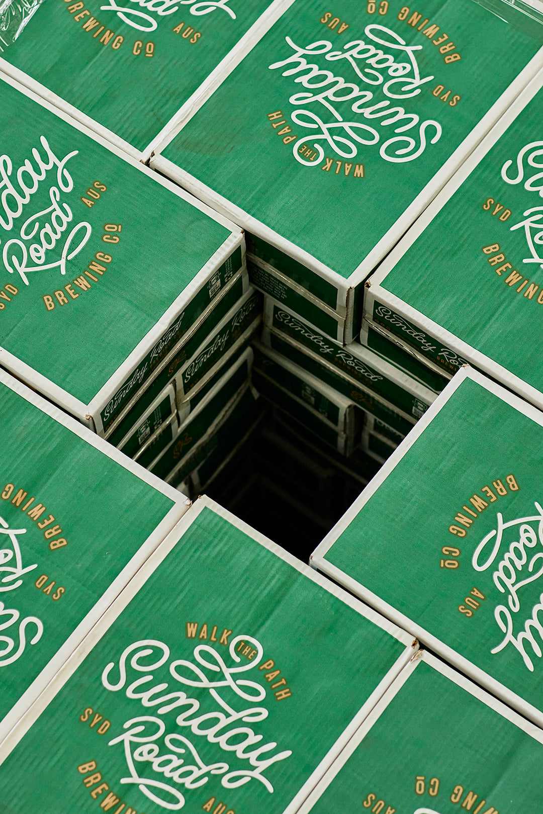 Stack of green Sunday Road Brewing Co. beer cases.
