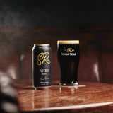 Sunday Road Nitro Stout can and glass on a wooden table with a dark background