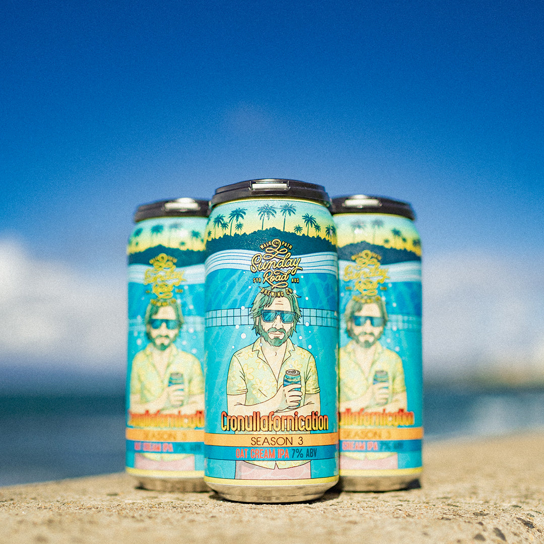 Three beer cans with a tropical design on a beach with ocean in the background Sunday Road Brewing cronullafornication season 3 oat cream ipa